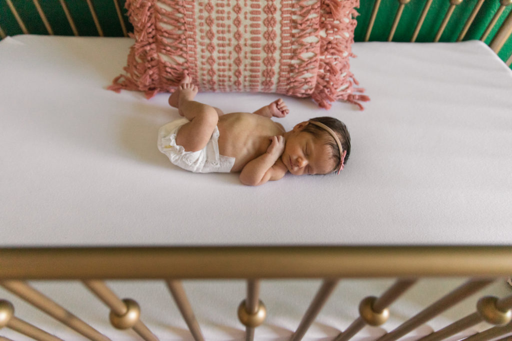 sleeping newborn baby in crib