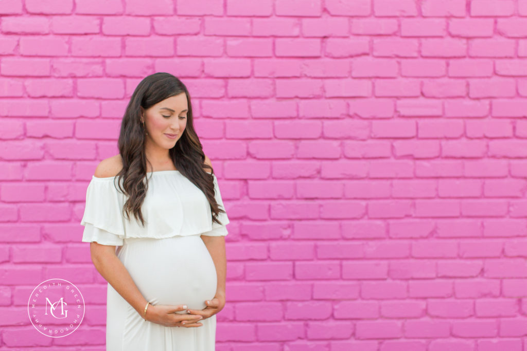 Maternity session with pink wall backdrop