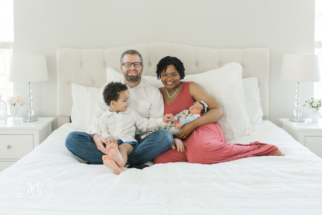 Newborn Lifestyle Session with the whole family in master bedroom
