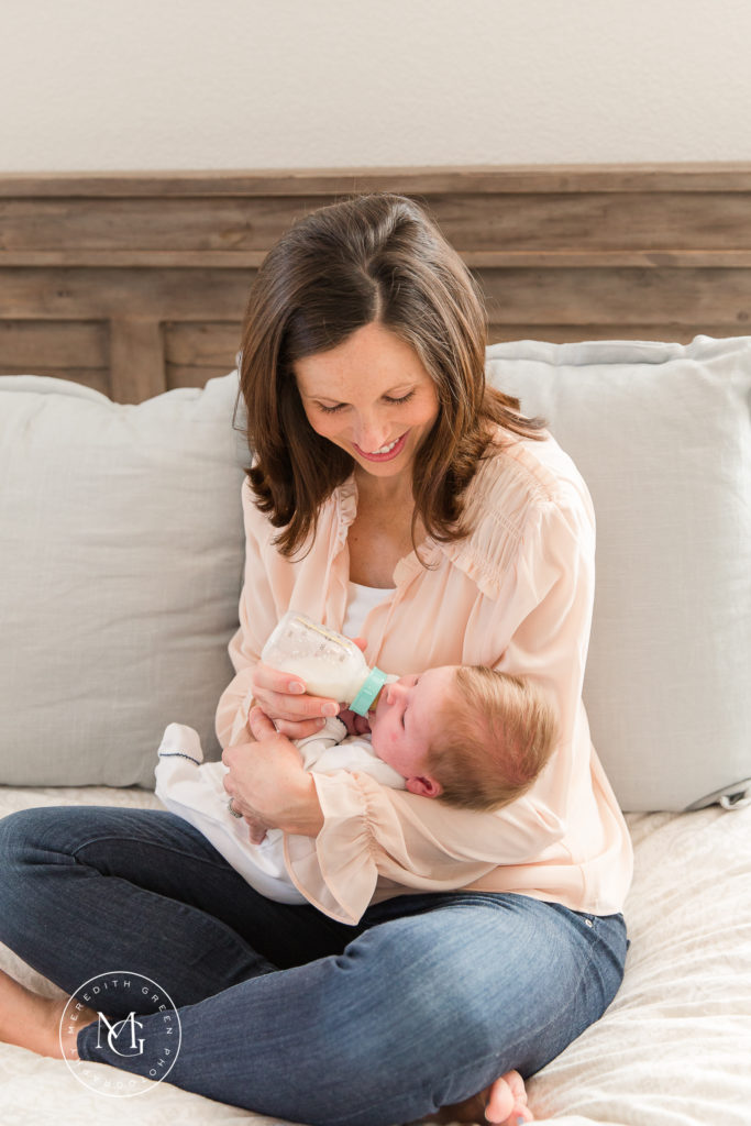 mother holding baby during newborn lifestyle session