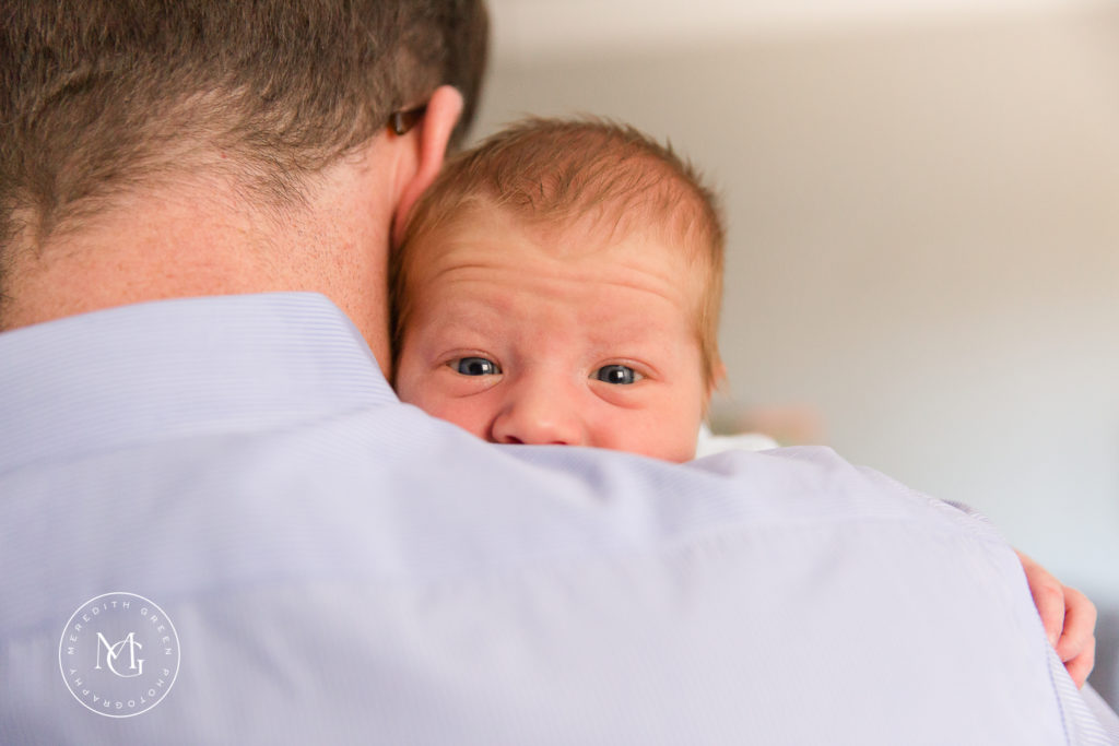 Dad holding baby during newborn lifestyle session