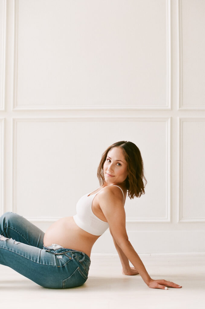 Mother sitting on floor posing during photo session