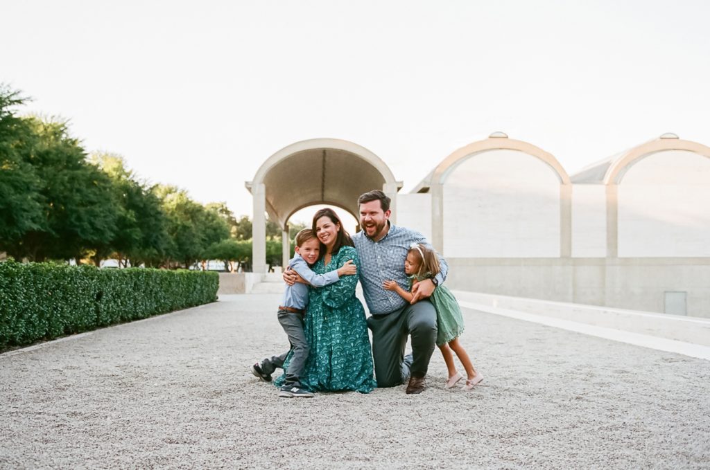 Hunt family posing in front of Kimbell Art Museum during 