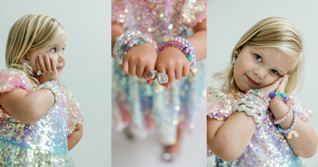 Little girl playing dress up with costume jewelery for milestone photo session