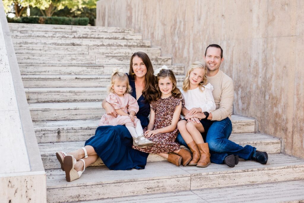 McCord family sitting on steps at Kimbell Art Museum for fall family photos