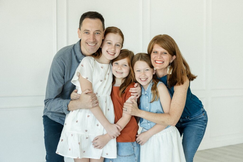 Rollings family hugging for a family picture during their studio session