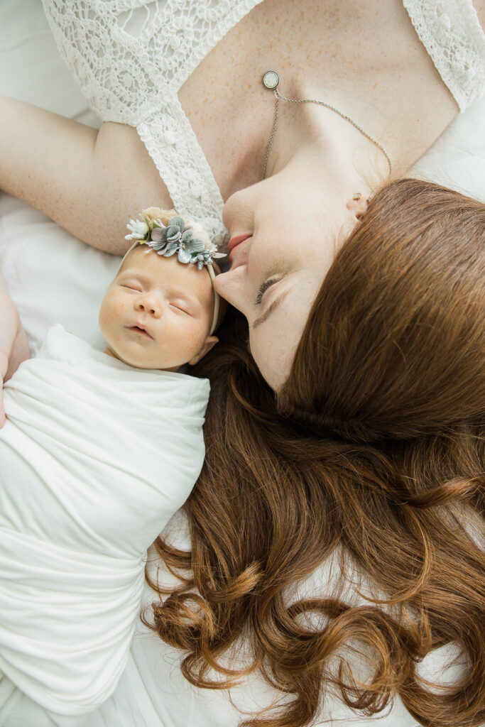 Newborn snuggling with mom