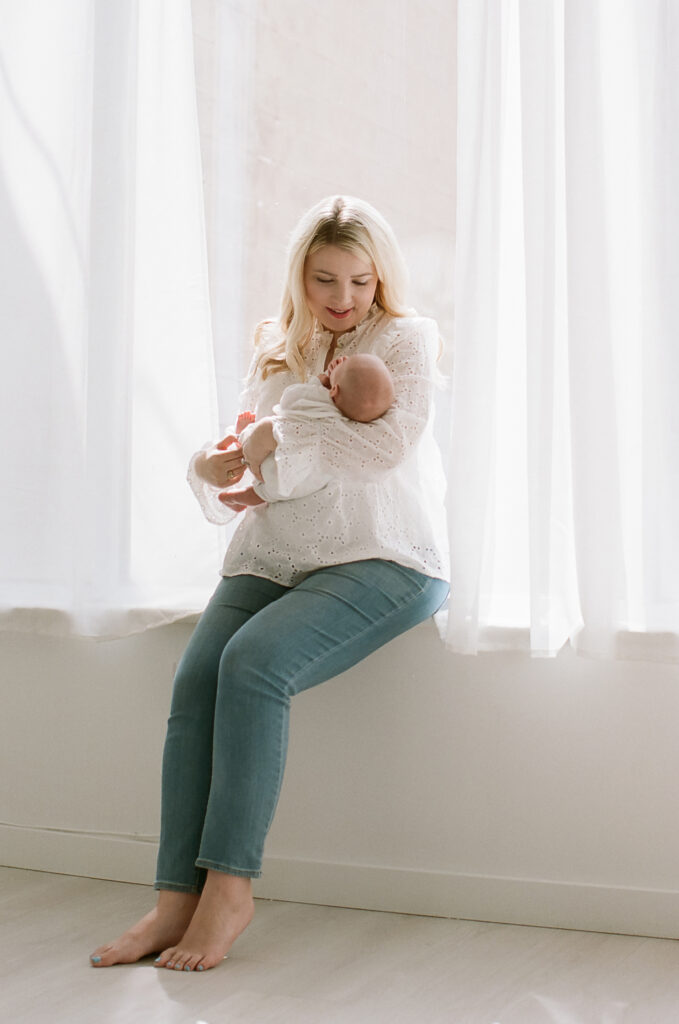 Mother holding daughter during newborn photos