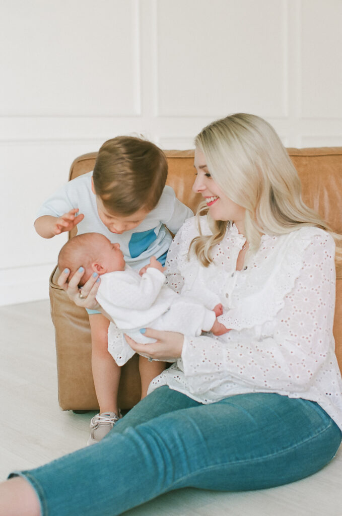 Mother and son holding newborn sister