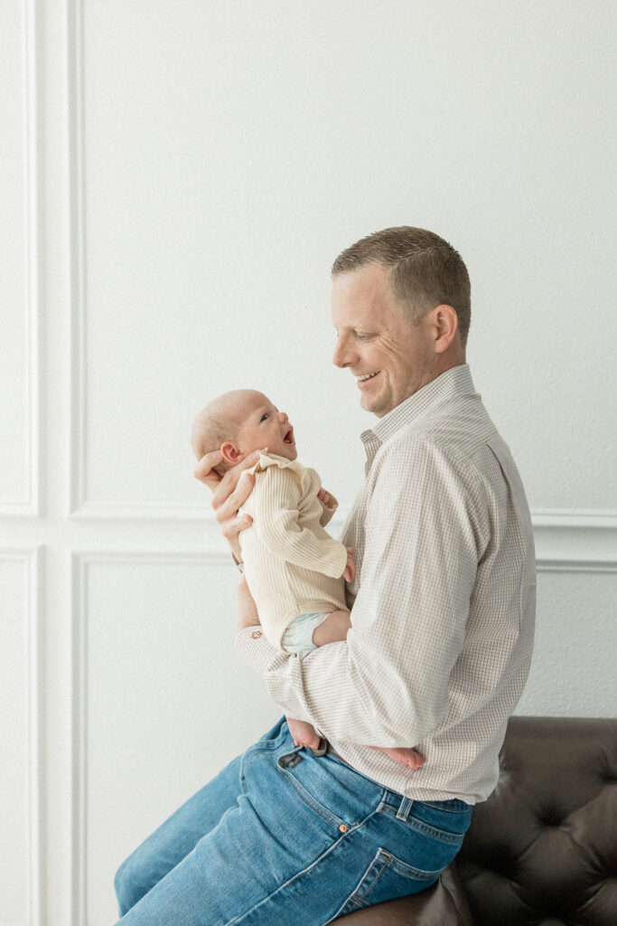 Father holding newborn daughter